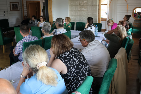 Group of people sitting in a conference room.