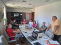 People sitting on a table in an office.